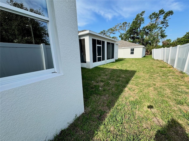 view of yard with a sunroom and fence