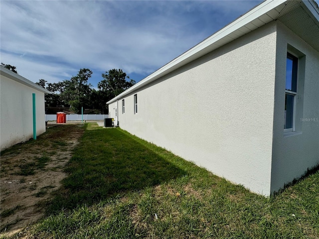 view of property exterior featuring a lawn and stucco siding