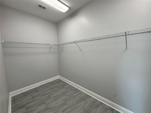 spacious closet featuring visible vents