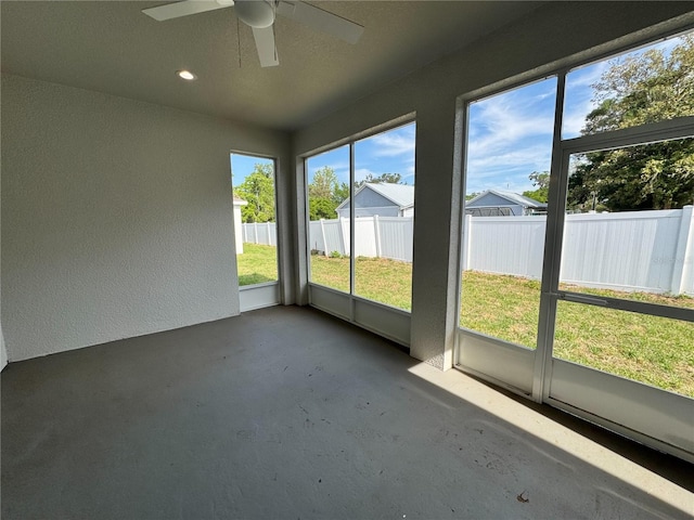 unfurnished sunroom featuring ceiling fan
