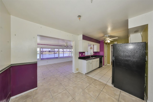 kitchen featuring a ceiling fan, white cabinetry, a sink, and black appliances