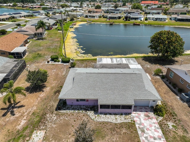 drone / aerial view with a water view and a residential view