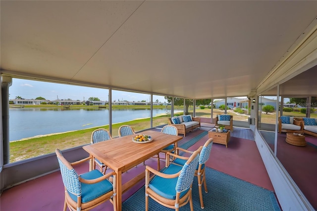 sunroom featuring a water view, a healthy amount of sunlight, and an outdoor hangout area
