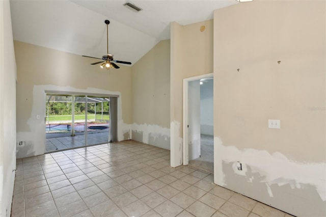 spare room featuring visible vents, a ceiling fan, light tile patterned floors, and high vaulted ceiling