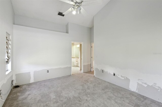 unfurnished room with a ceiling fan, high vaulted ceiling, visible vents, and carpet