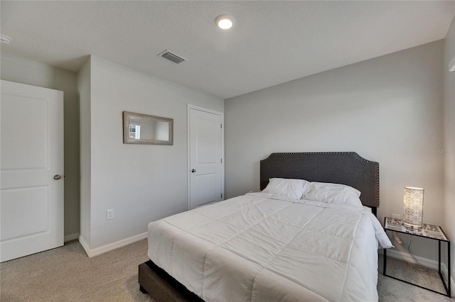 bedroom featuring light carpet and baseboards