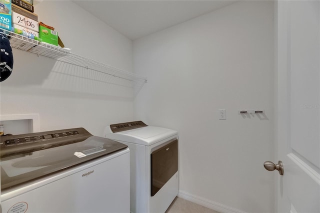 laundry room featuring washer and clothes dryer and baseboards