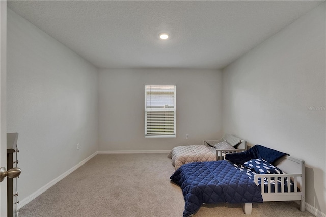 carpeted bedroom featuring baseboards