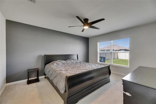 carpeted bedroom featuring baseboards and a ceiling fan