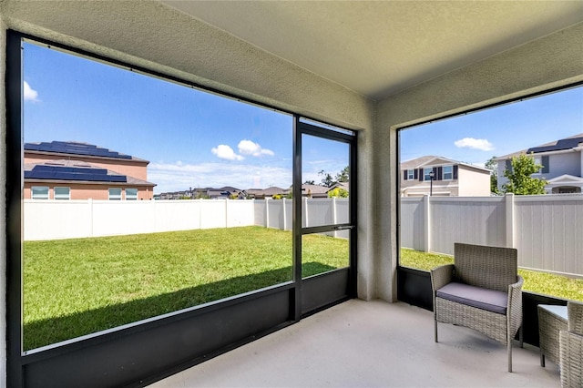 sunroom / solarium featuring a residential view