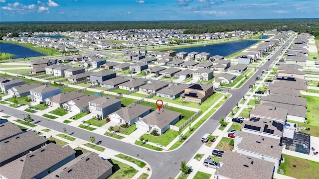view of property location featuring a nearby body of water and nearby suburban area
