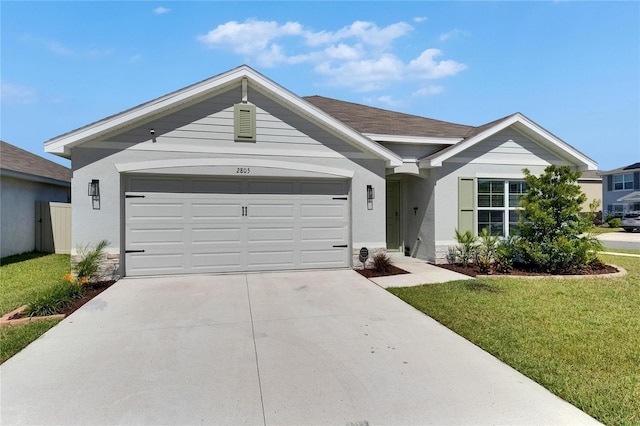 ranch-style home with driveway, a front yard, a garage, and stone siding