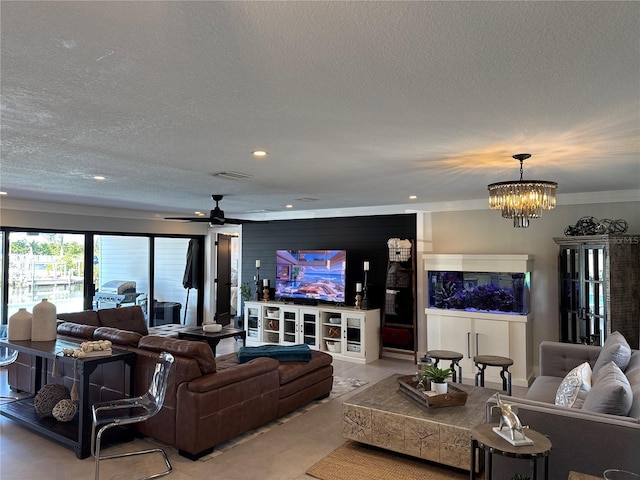 926 Eagle Ln, Apollo Beach, FL 33572 - living room with a textured ceiling, ceiling fan with notable chandelier, recessed lighting, visible vents, and ornamental molding