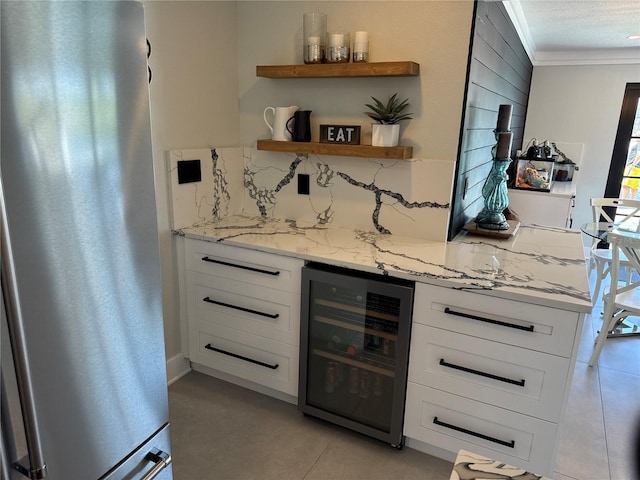 926 Eagle Ln, Apollo Beach, FL 33572 - bar featuring crown molding, a dry bar, beverage cooler, freestanding refrigerator, and decorative backsplash