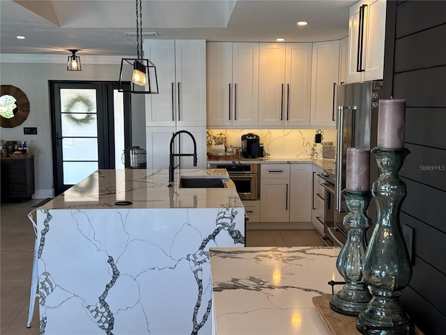 926 Eagle Ln, Apollo Beach, FL 33572 - kitchen featuring white cabinets, oven, light stone counters, a sink, and recessed lighting