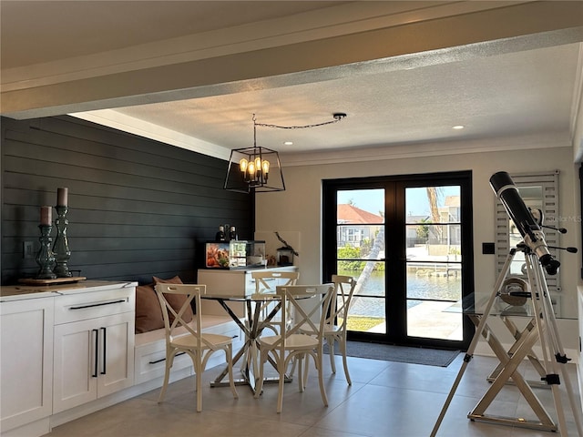 926 Eagle Ln, Apollo Beach, FL 33572 - dining area featuring crown molding, a textured ceiling, wood walls, and french doors