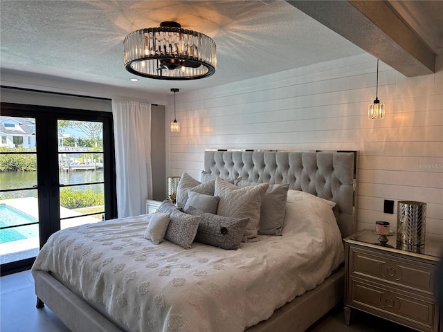 926 Eagle Ln, Apollo Beach, FL 33572 - bedroom with a water view, recessed lighting, a textured ceiling, and access to exterior