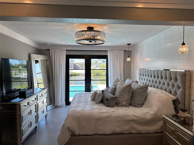 926 Eagle Ln, Apollo Beach, FL 33572 - bedroom with a chandelier, concrete floors, a textured ceiling, and access to exterior