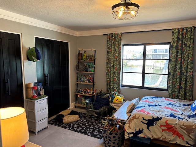 926 Eagle Ln, Apollo Beach, FL 33572 - tiled bedroom featuring a textured ceiling