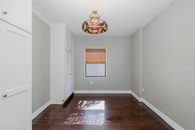 unfurnished bedroom featuring baseboards and dark wood-style floors
