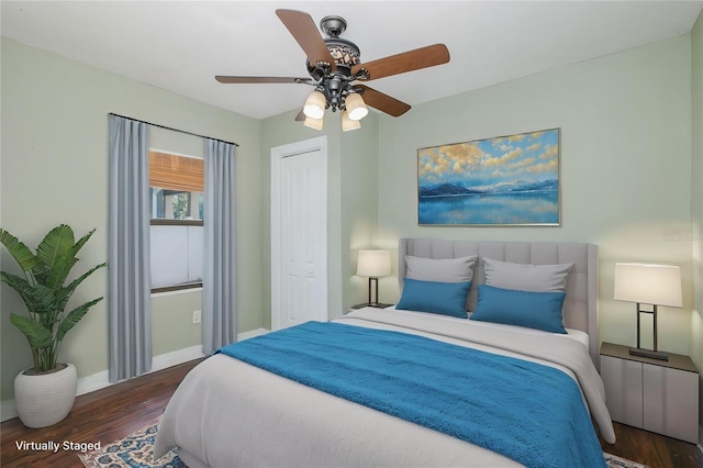 bedroom featuring baseboards, ceiling fan, wood finished floors, and a closet