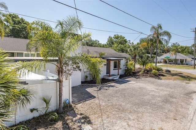 view of front of property featuring fence and stucco siding