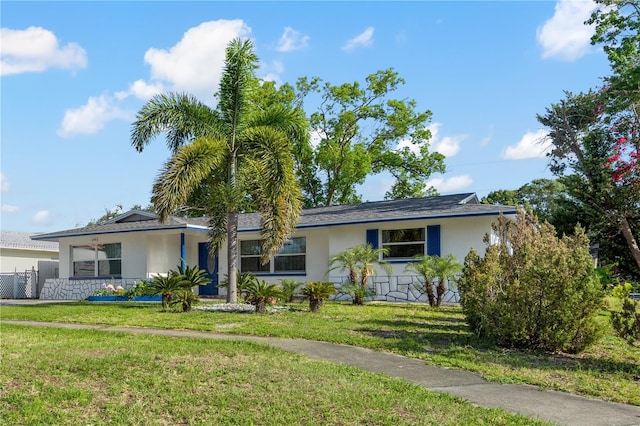 1099 7th Ave NE, Largo, FL 33770 - single story home with fence, stucco siding, and a front lawn