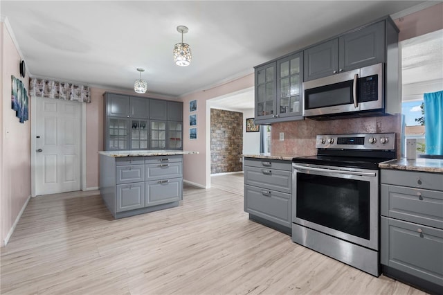 1099 7th Ave NE, Largo, FL 33770 - kitchen featuring baseboards, gray cabinets, tasteful backsplash, and stainless steel appliances