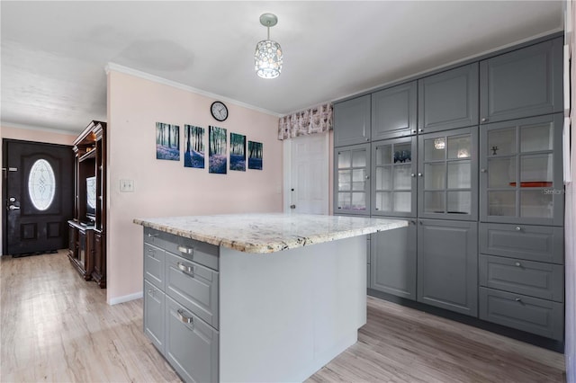 1099 7th Ave NE, Largo, FL 33770 - kitchen with a kitchen island, gray cabinets, and light wood-style floors