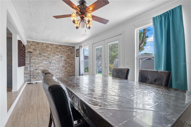 1099 7th Ave NE, Largo, FL 33770 - dining space featuring crown molding, ceiling fan, french doors, and wood finished floors