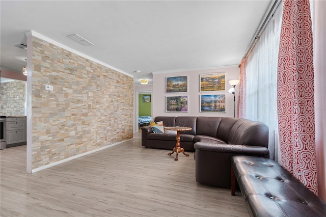 1099 7th Ave NE, Largo, FL 33770 - living area with crown molding, visible vents, and light wood-style floors