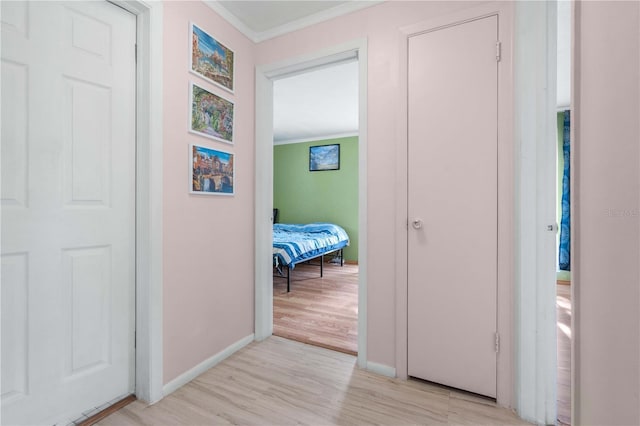 1099 7th Ave NE, Largo, FL 33770 - hall featuring crown molding, baseboards, and light wood-type flooring