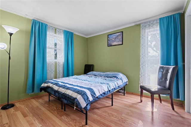 1099 7th Ave NE, Largo, FL 33770 - bedroom with crown molding, baseboards, and wood finished floors