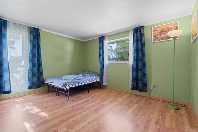 1099 7th Ave NE, Largo, FL 33770 - bedroom featuring crown molding, baseboards, and wood finished floors