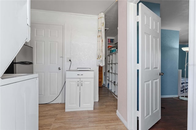 1099 7th Ave NE, Largo, FL 33770 - laundry room featuring light wood-type flooring, washer / dryer, and baseboards