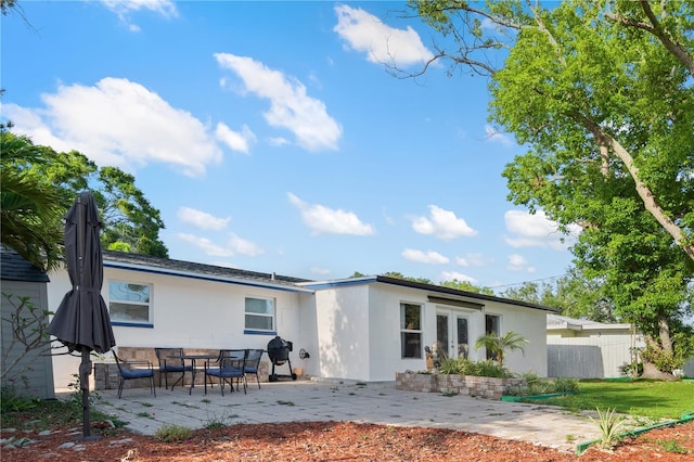 1099 7th Ave NE, Largo, FL 33770 - back of house with a patio, fence, french doors, and stucco siding