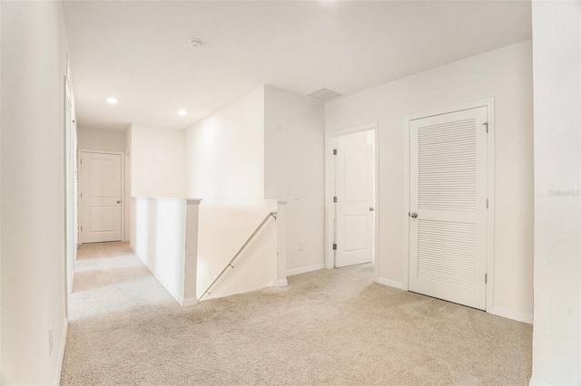 empty room featuring recessed lighting, visible vents, carpet, and baseboards