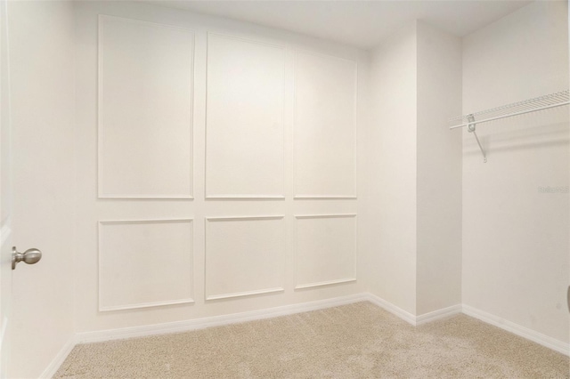 walk in closet with carpet flooring