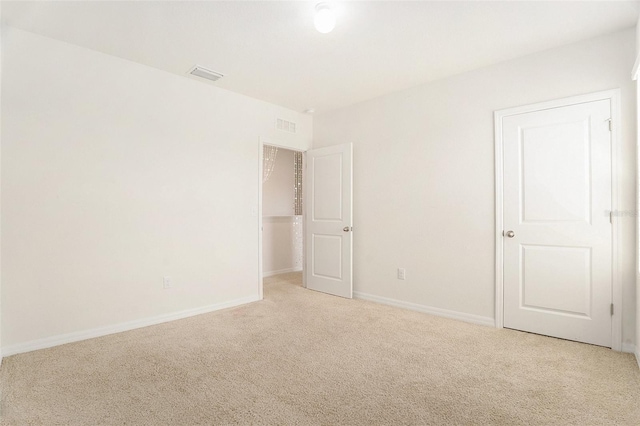 interior space featuring carpet flooring, visible vents, and baseboards
