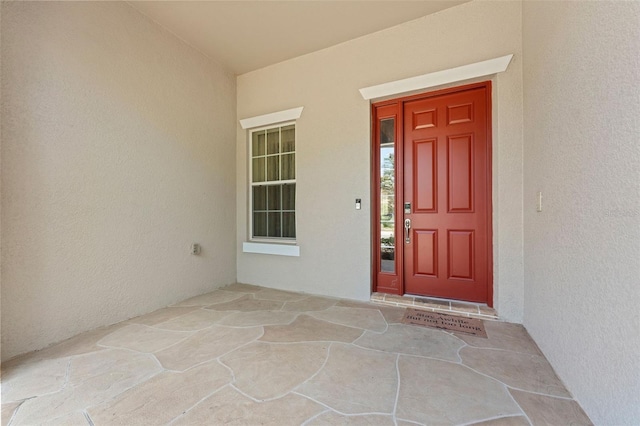 view of exterior entry featuring stucco siding