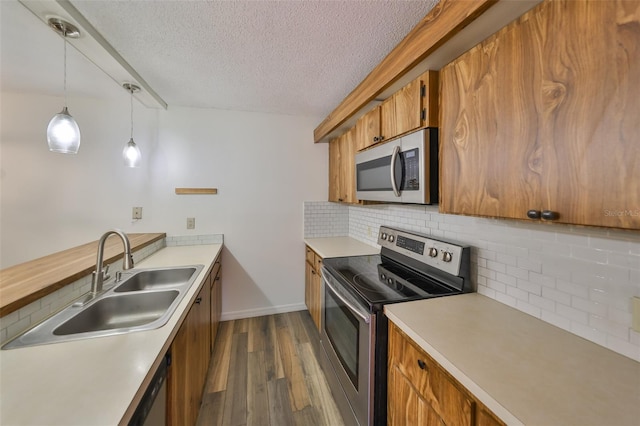 2627 2nd Ct, Palm Harbor, FL 34684 - kitchen featuring brown cabinets, appliances with stainless steel finishes, dark wood-style floors, and a sink