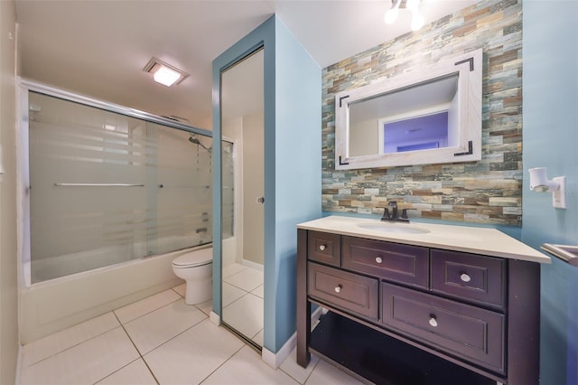 2627 2nd Ct, Palm Harbor, FL 34684 - bathroom featuring tile patterned flooring, vanity, toilet, baseboards, and bath / shower combo with glass door