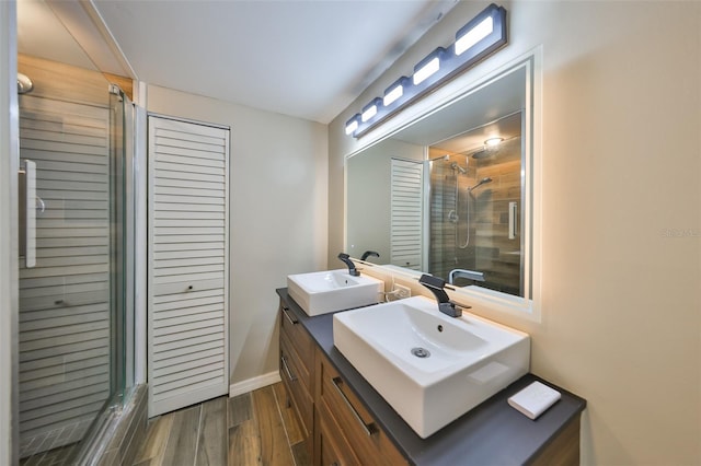2627 2nd Ct, Palm Harbor, FL 34684 - full bath featuring a sink, baseboards, a shower stall, and wood finished floors