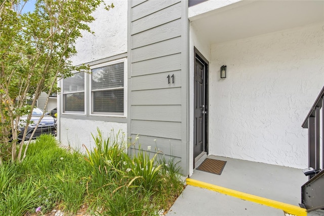 view of exterior entry with stucco siding
