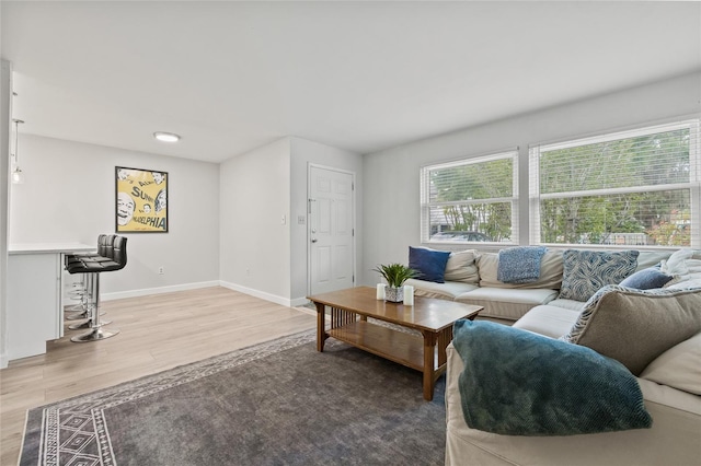 living room featuring baseboards and light wood finished floors