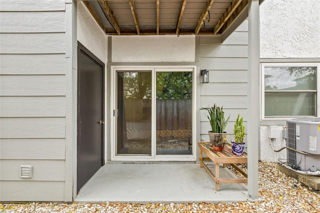 view of exterior entry with central air condition unit