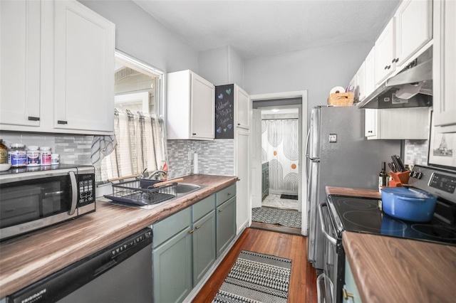 2235 Burlington Ave N, Saint Petersburg, FL 33713 - kitchen featuring a sink, butcher block counters, under cabinet range hood, and stainless steel appliances