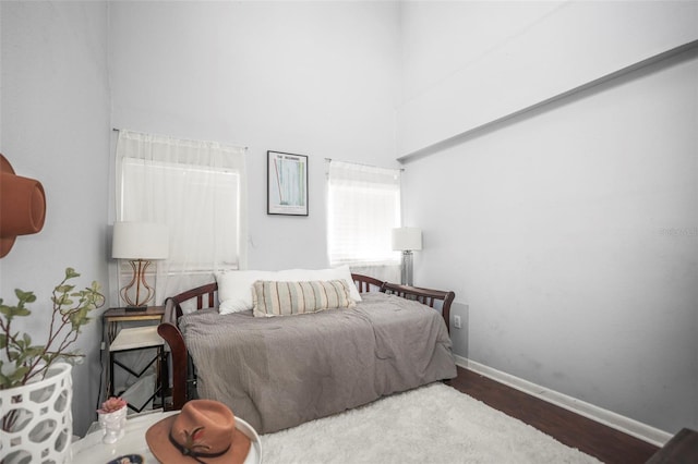 2235 Burlington Ave N, Saint Petersburg, FL 33713 - bedroom featuring baseboards, wood finished floors, and a towering ceiling