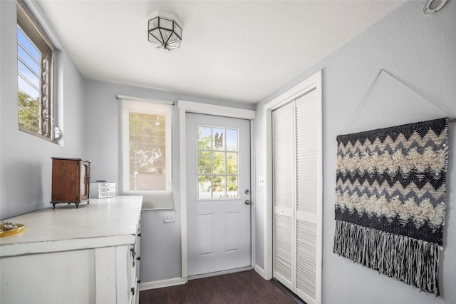 2235 Burlington Ave N, Saint Petersburg, FL 33713 - doorway with baseboards and dark wood-style flooring