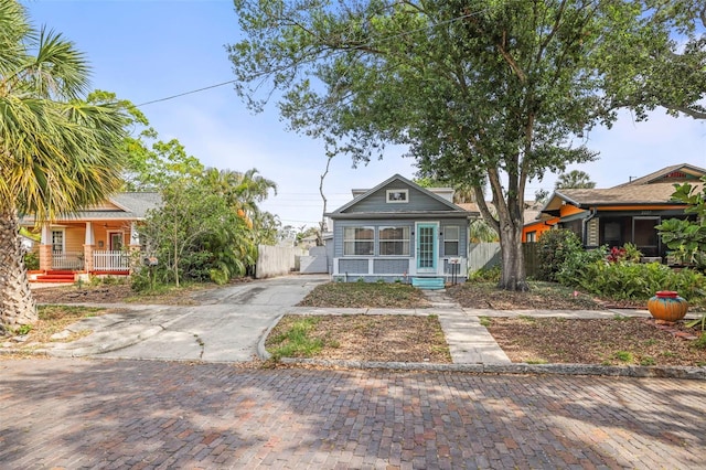 2235 Burlington Ave N, Saint Petersburg, FL 33713 - view of front of house with a gate, fence, covered porch, and concrete driveway